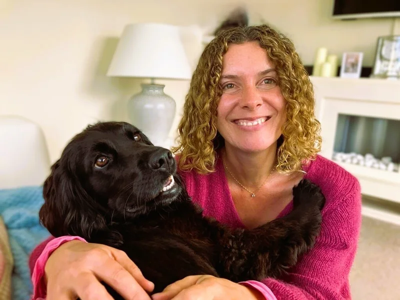 Natalia nutritional therapist in a relaxed moment at home with her dog